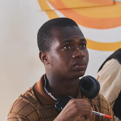 Portrait of Ezechukwu Miracle wearing headphones around his neck
